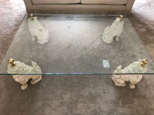 A large modern Chinese style coffee table, having four Chinese temple dogs in what appears to be