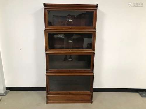 A set of four wooden and glazed library bookcases by Globe-Wernicke Co Ltd, with base and cornice,