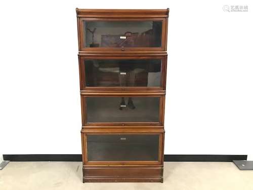 A set of four wooden and glazed library bookcases by Globe-Wernicke Co Ltd, with base and cornice,