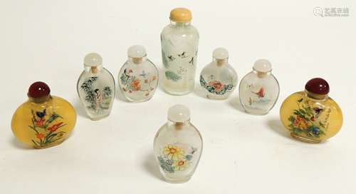 A small group of Chinese reverse glass painted snuff bottles, including a near pair decorated with