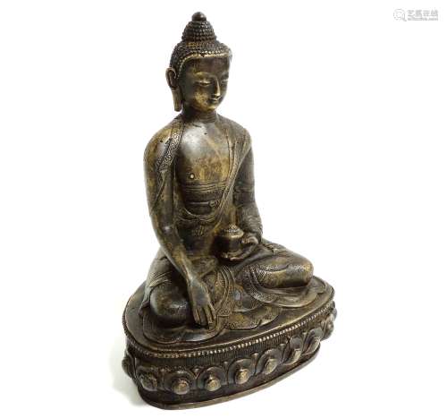 A Chinese bronze figure of Buddha, seated cross legged, raised on a lotus pedestal base, height 21.