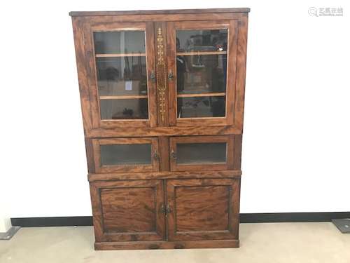 A walnut display cabinet, of rectangular form with two pairs of glazed doors and a pair of panel