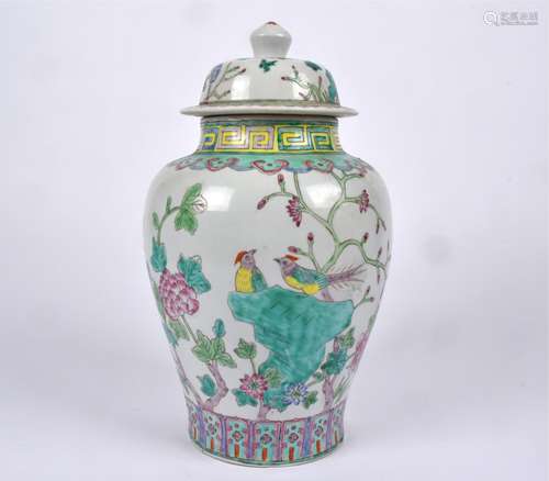 A Chinese covered jar with Famille rose decoration, with lotus panels, rising to a study of birds