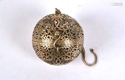 An Islamic white metal incense burner, of pierced spherical foliate form, length on chain 12cm