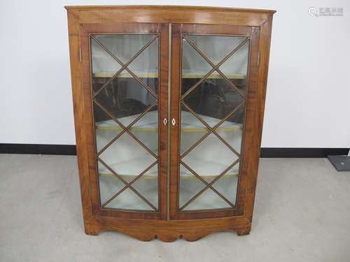 A Georgian mahogany wall hanging corner cupboard, shaped pediment, astragal glazed doors with