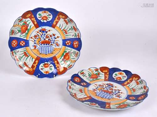 Two Japanese Imari floriform plates, with central design of flowers in a basket, diameter 31cm (2)