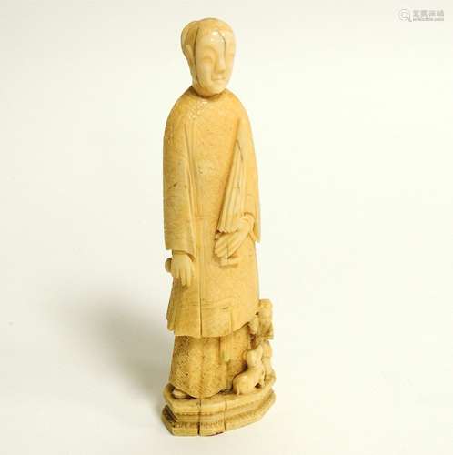 A Chinese marine ivory carving of a lady with an umbrella, probably walrus, with a young child and