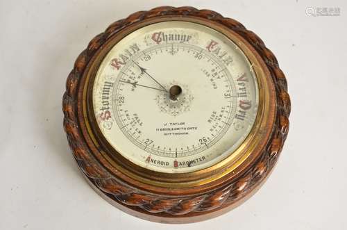 A 20th Century oak circular aneroid barometer, marked 'J. Taylor' '11 Briddlesmith Gate,