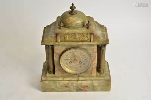 A French green onyx early 20th Century mantel clock, with Ionic columns and a classical frieze to