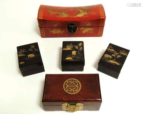 Three Chinese black lacquer boxes each with gilt enamelling of buildings and rocky islands, 11cm x