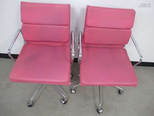 A pair of contemporary Eames style low back soft pad chairs, chrome frames and upholstered in a faux