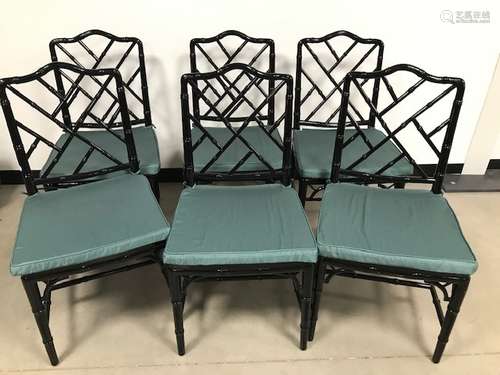 A set of six modern faux bamboo black painted dining chairs, with rattan seats and green upholstered