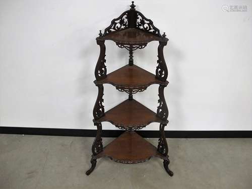 A Victorian mahogany floor standing four tier corner whatnot, pie crust moulded edges to shelf