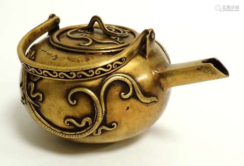 A Chinese bronze teapot on triform feet, of squat form, the sides with mythical beasts in archaistic