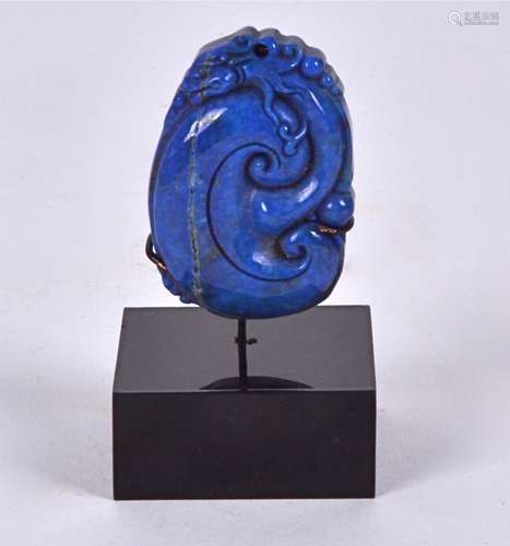 A Lapis Lazuli block mounted on contemporary stand, taking the form of a coiled chilong dragon,