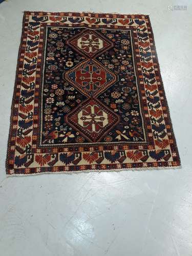 Old Middle Eastern Rug, a bordered example with blue ground central field decorated with three large