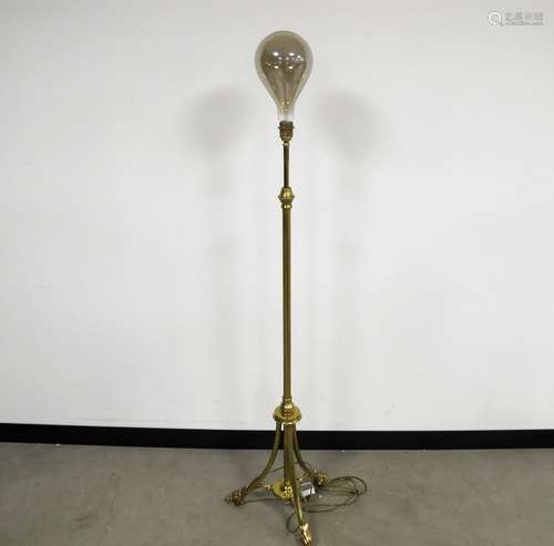 A Victorian extendable brass standard lamp, tripod base, fitted with large modern bulb with a spiral