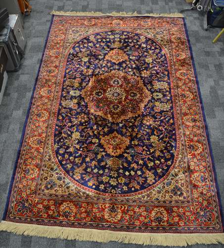 A Sarook Kashan silk rug, the central foliated shape containing alternating floral designs,