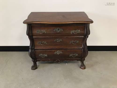 A c1950s stained small chest of drawers, bombe style with three drawers having brass handles, 66