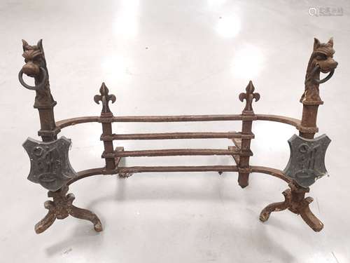 A vintage cast iron fire basket surround, with shields and heraldic figures to either side, sold