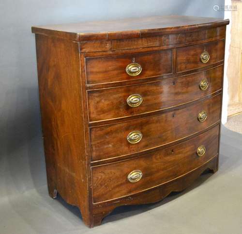 A 19th Century Mahogany Bow Fronted Chest of two short and three long graduated drawers with oval