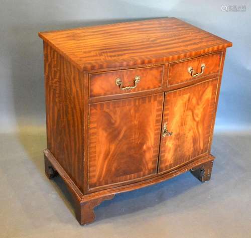 A 20th Century Mahogany Serpentine Side Cabinet with two drawers above two doors raised upon bracket