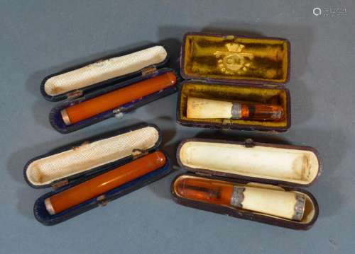 An Amber Yellow Metal Mounted Cheroot with case together with another similar together with two