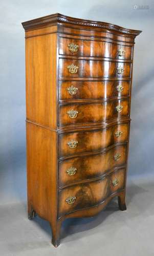 An Early 20th Century Walnut Serpentine Chest on Chest, the moulded cornice above seven graduated