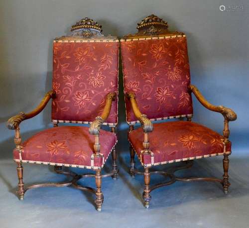 A Pair of Early 20th Century Italian Walnut Large Armchairs each with a carved cresting above a