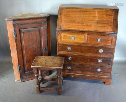 A Mahogany Bureau, the fall front enclosing a fitted interior above two short and three long drawers