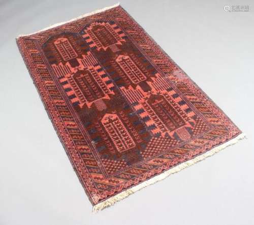 An Afghan Woollen Rug with six medallions upon a red and blue ground within multiple boarders