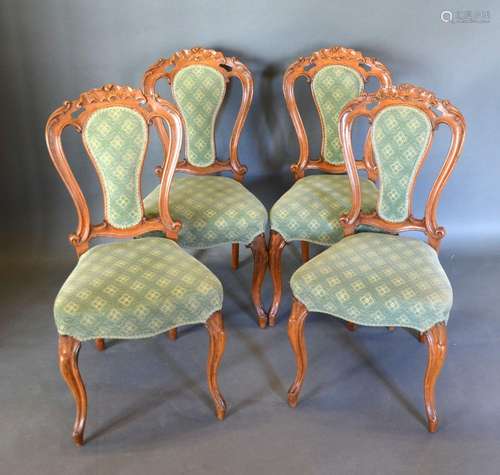 A Set of Four Victorian Drawing Room Side Chairs with partly upholstered and carved pierced backs