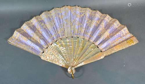 A Lace Fan backed with lilac satin with mother-of-pearl sticks and guards with gilded monogram