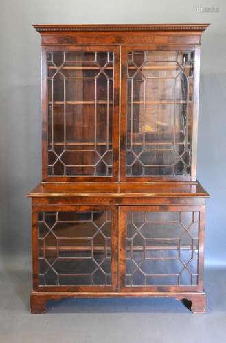 An Edwardian Mahogany Display Cabinet, the moulded cornice above two astragal glazed doors enclosing