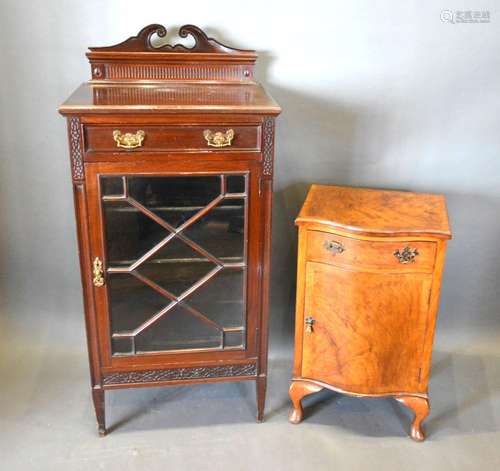 An Edwardian Mahogany Music Cabinet with an astragal glazed door enclosing shelves together with