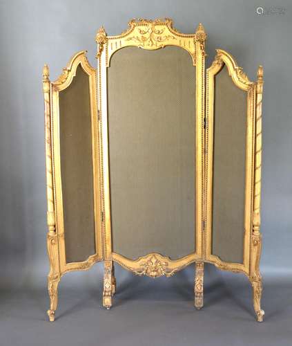 A Late 19th Early 20th Century French Gilded Three Fold Screen with a bow carved cresting raised