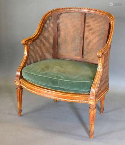 A Late 19th Century French Fauteuil, the cane back and sides with scroll arms raised upon turned