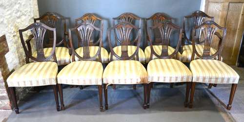 A Set of Ten Mahogany Dining Chairs each with a shield wheatsheaf splat back above an upholstered