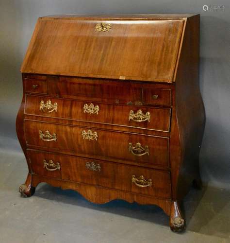 A Continental Mahogany Bombe Bureau, the fall front enclosing a fitted interior above two short