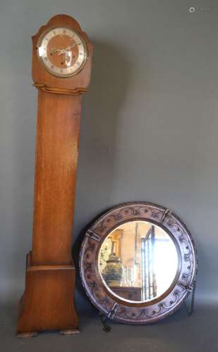An Early 20th Century Oak Circular Wall Mirror, together with an early 20th century oak longcase