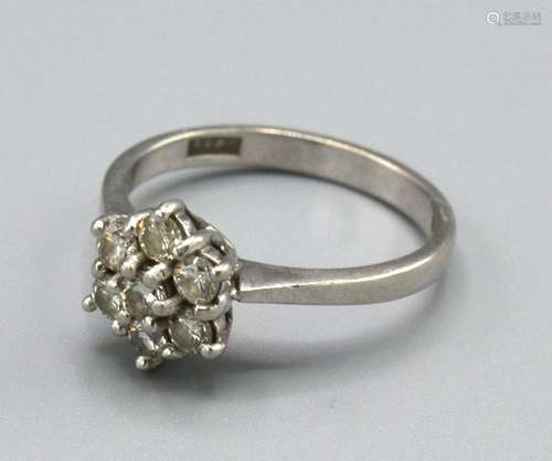 A Platinum Diamond Cluster Ring set with seven diamonds within a pierced setting, Size N, 4.5 grams