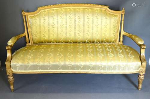 An Early 20th Century French Gilded Salon Sofa with an upholstered back and seat with scroll arms