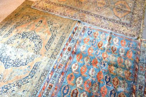 A North West Persian Woollen Rug with a central medallion within an all-over design upon a blue