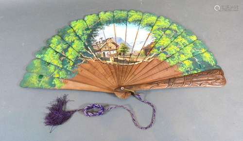 A Black Forest Carved Wooden Brise Fan hand painted with continental lake scene amongst foliage 23cm