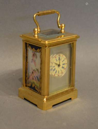 A Miniature Brass Cased Carriage Clock the silvered dial with roman numerals and with painted