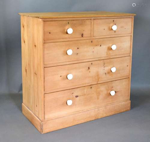 A Pine Straight Front Chest of two short and three long drawers with ceramic handles raised upon a