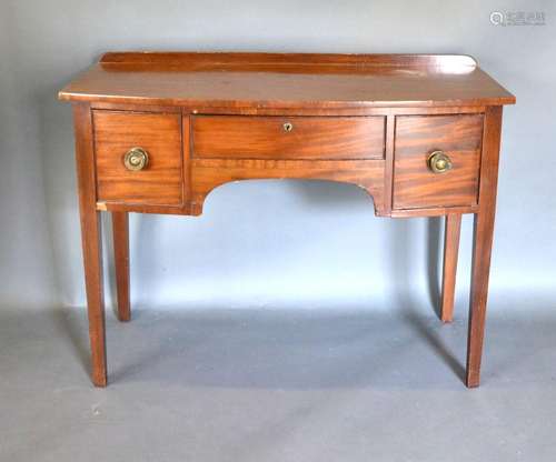 A Mahogany Bow Fronted Side Table with an arrangement of three drawers raised upon square tapering