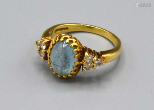 An 18ct. Gold Dress Ring with central cabochon moon stone flanked by six diamonds, claw set, ring