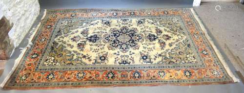 A North West Persian Woollen Rug with a central medallion within an all-over design upon a blue,
