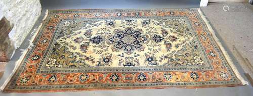 A North West Persian Woollen Rug with a central medallion within an all-over design upon a blue,